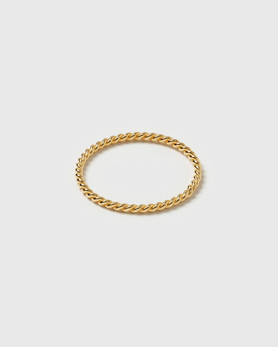 A product shot of the Tiny Twisted Ring Gold, highlighting its delicate, twisted band.
