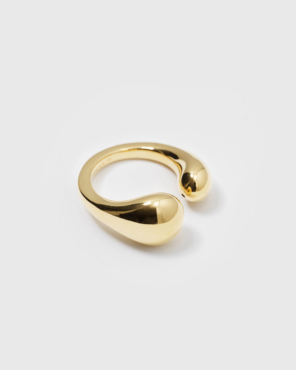 A product shot of the Bolded Drops Ring in gold, an open ring with a bold design featuring two teardrop-shaped ends.