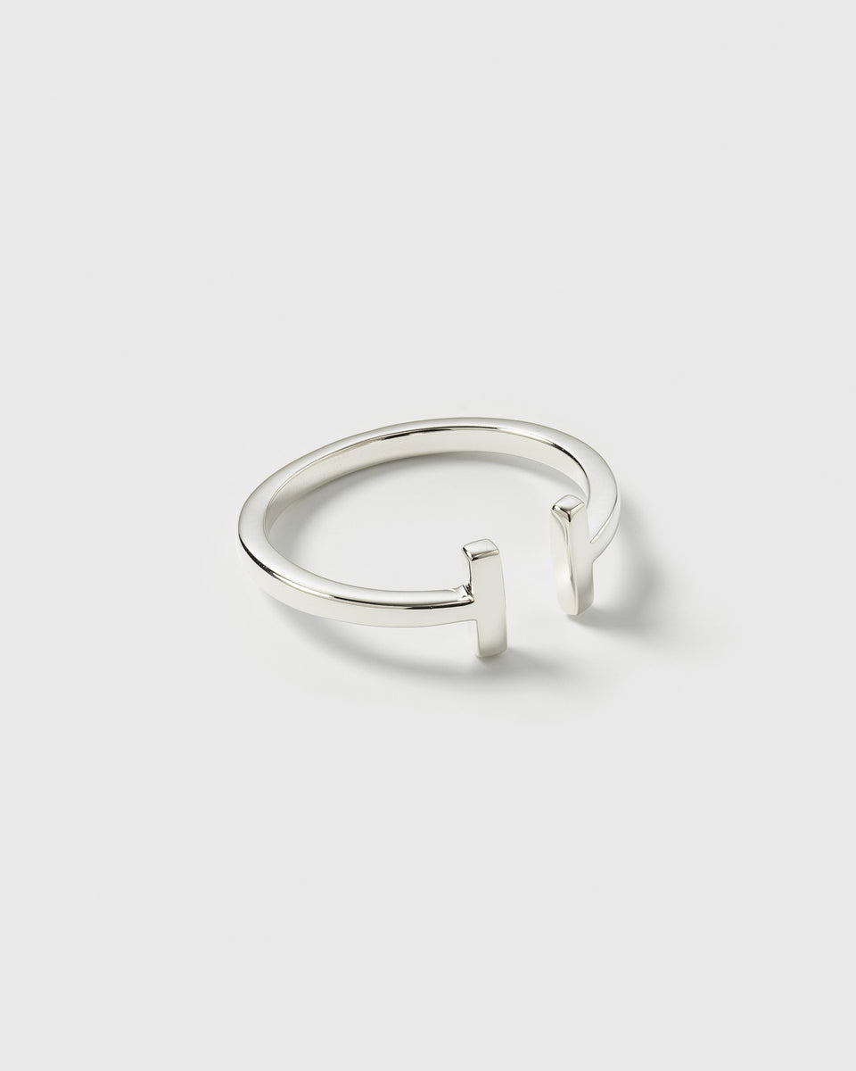A product shot of the Strict Bar Ring Silver, showcasing its adjustable open design with two vertical bars at the ends.