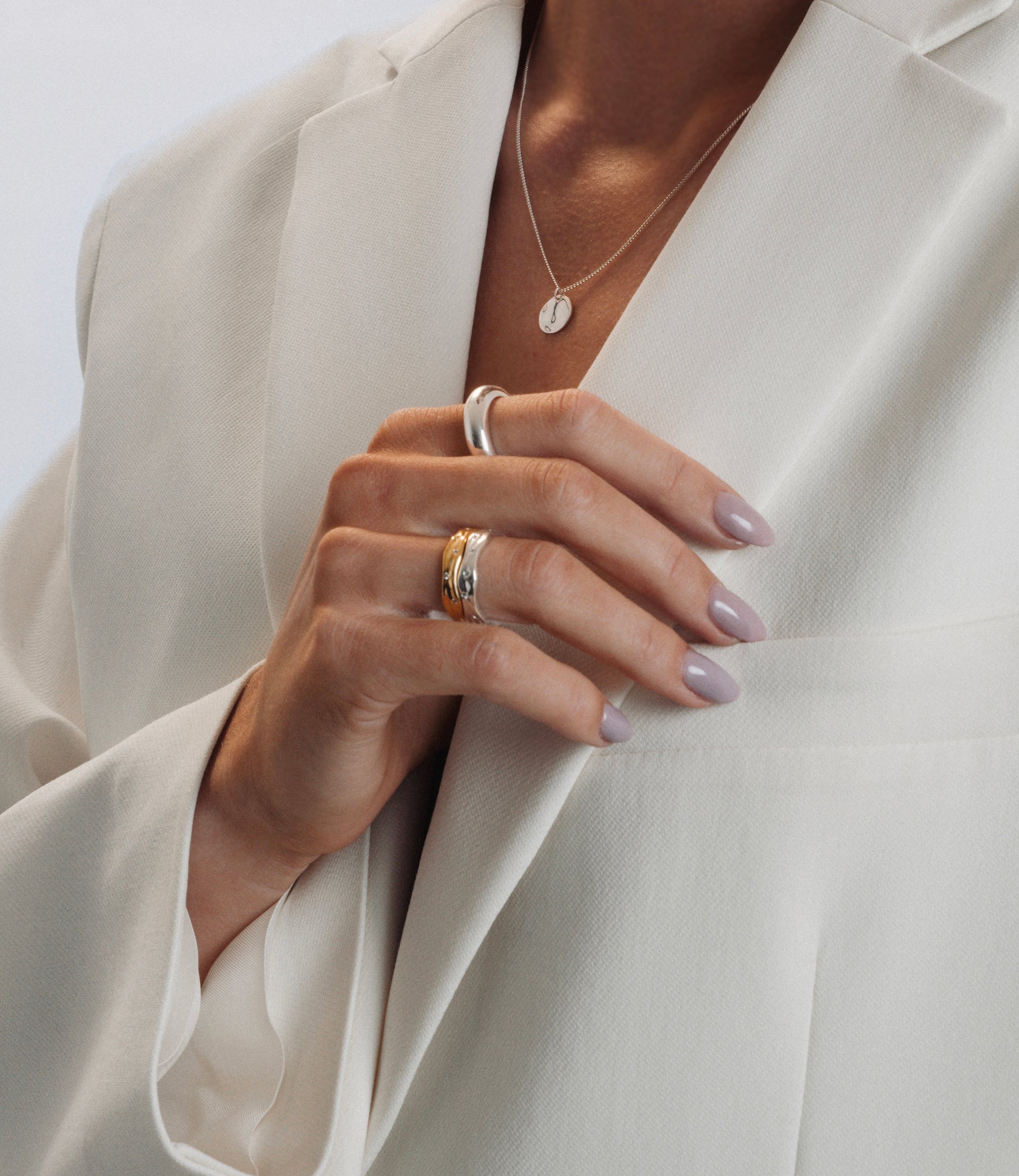 Silver and gold rings with zirconias styled together
