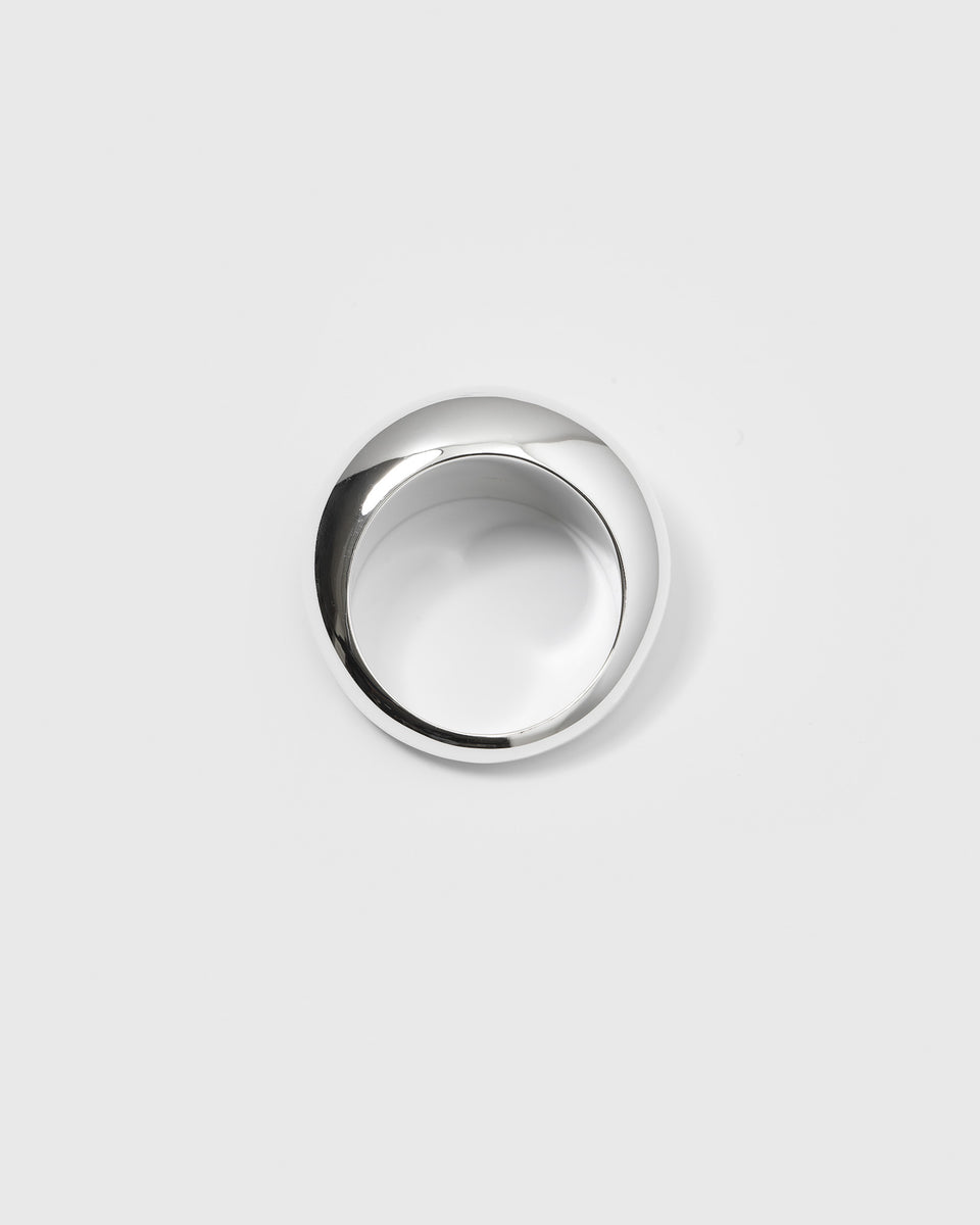 A product shot of the Bolded Big Ring in silver, seen from above to showcase its thick, rounded, and polished design.
