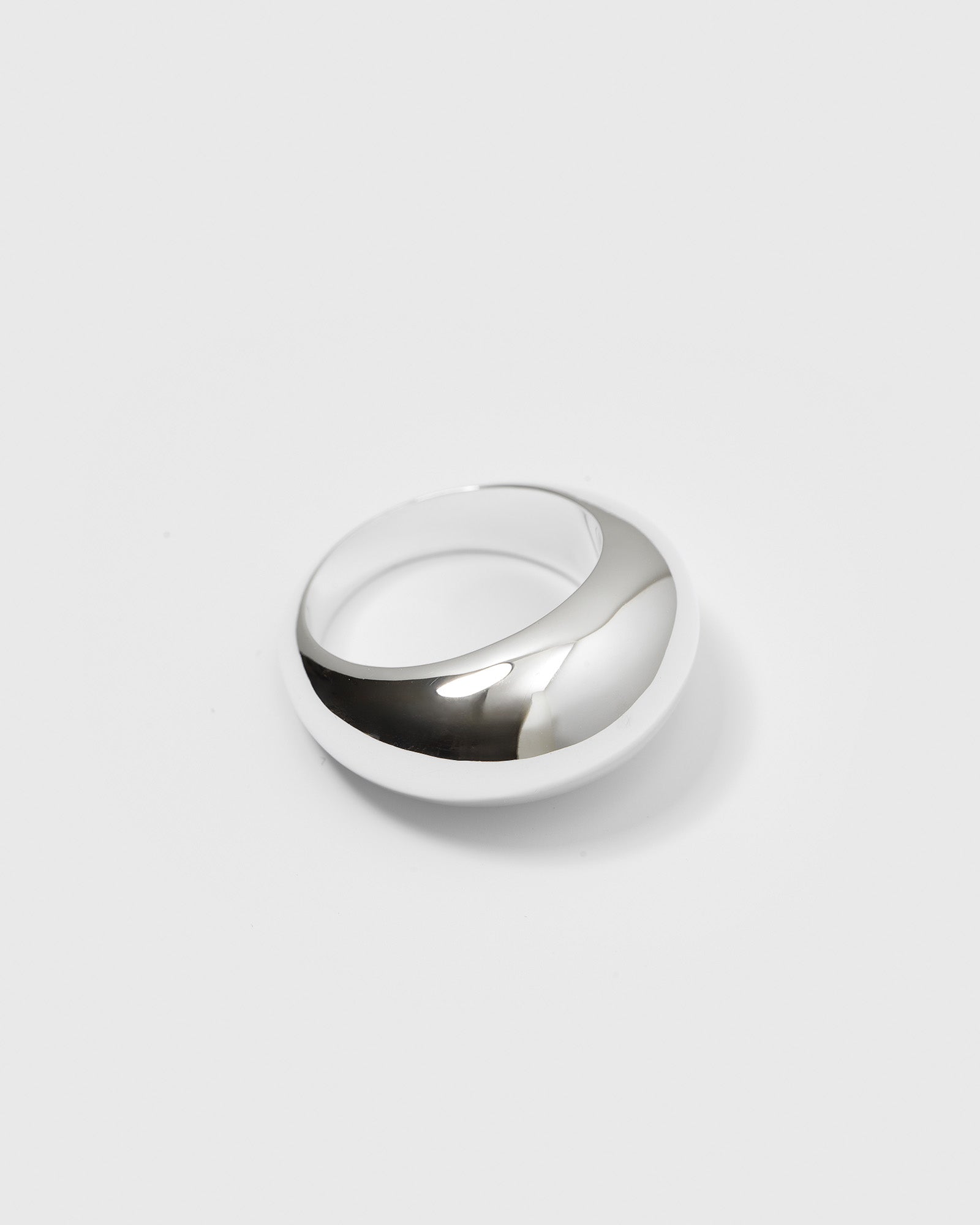 A product shot of the Bolded Big Ring Silver, showcasing its wide, polished, and rounded design.
