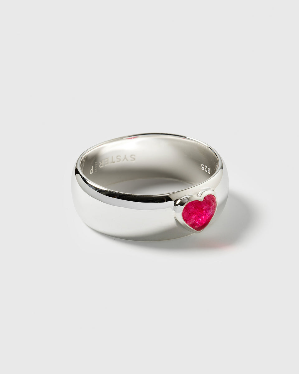 A close-up of the La La Love statement ring, crafted from polished recycled sterling silver with an inlaid heart-shaped pink quartz stone.