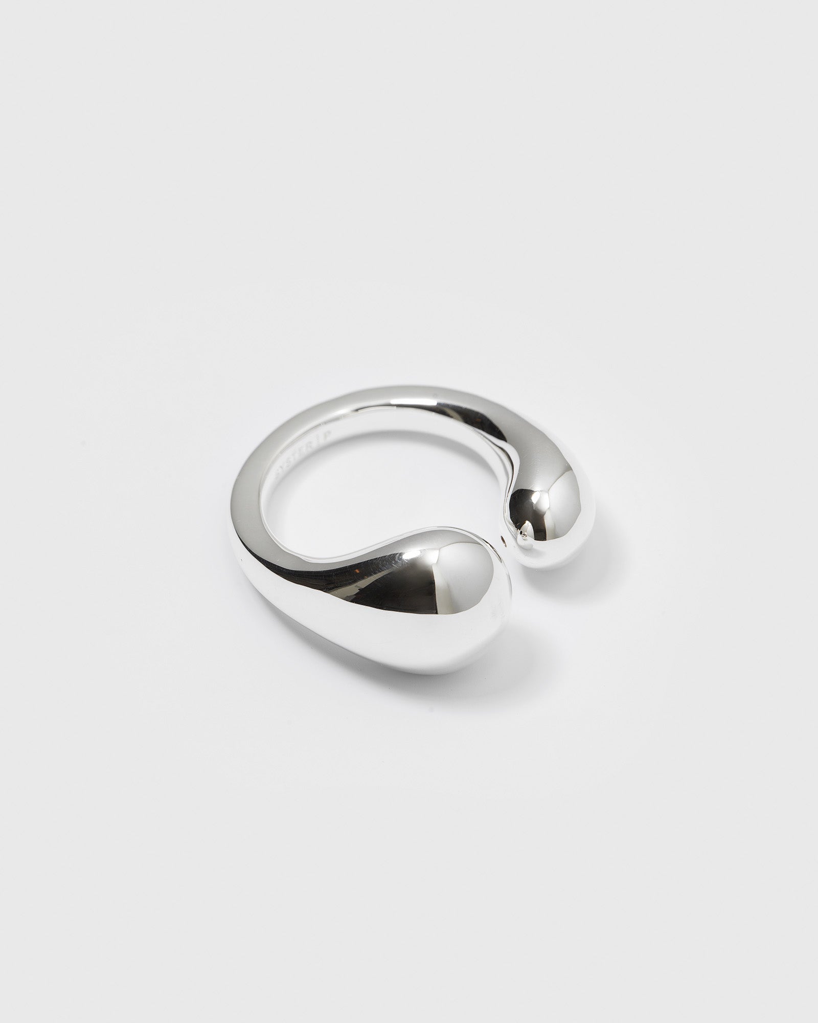 A product shot of the Bolded Drops Ring in silver, showcasing its open design with two bold, polished, drop-shaped ends.