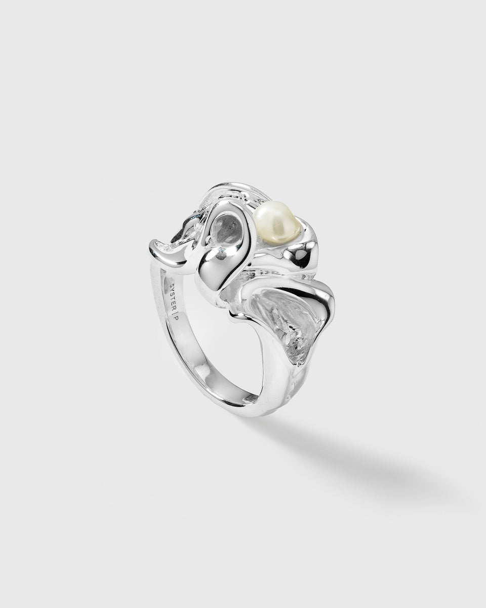 A product shot of the Moulded Big Ring Silver, showcasing its organic, irregular shape and a single freshwater pearl nestled into the design.
