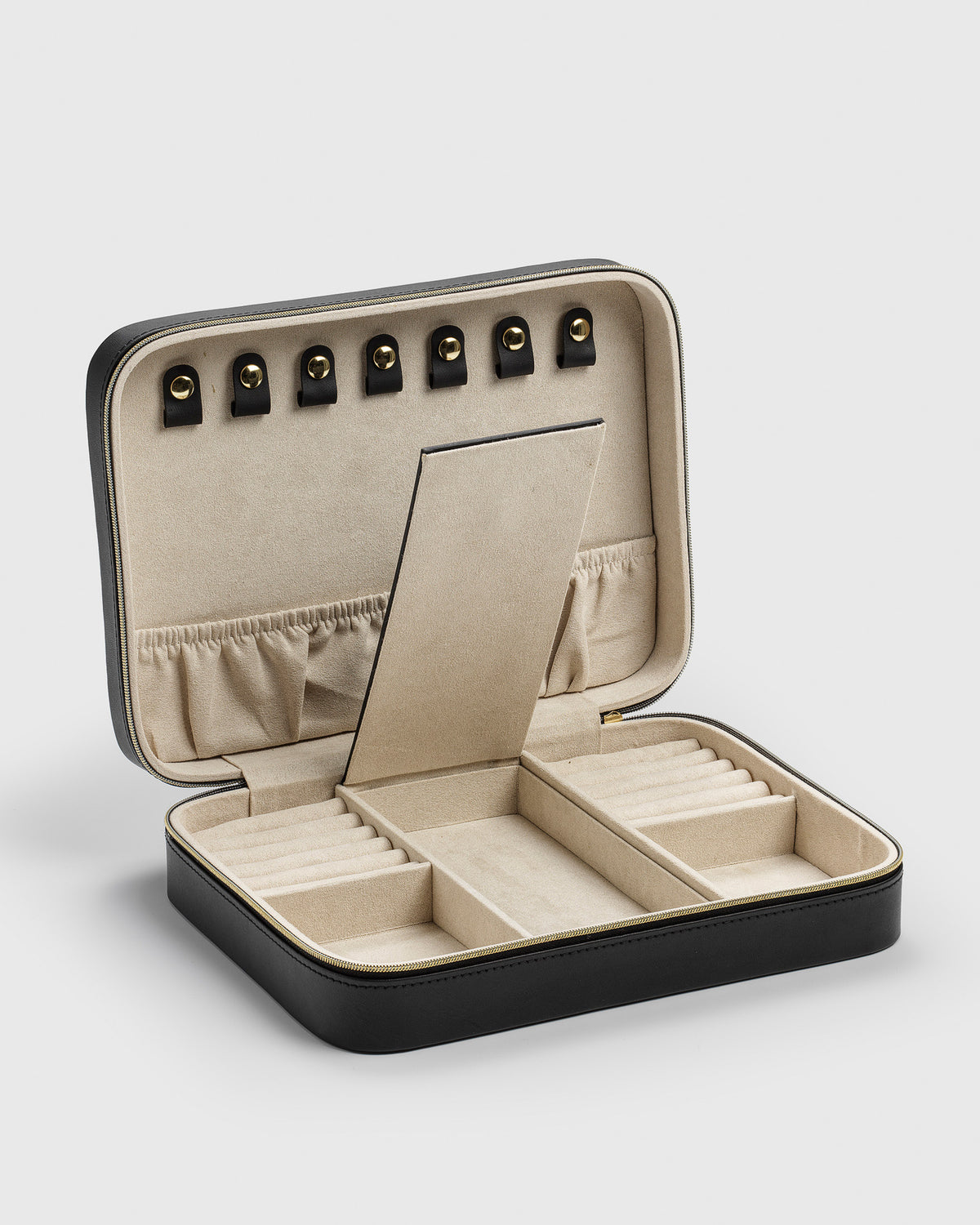 A product shot of the Jewelry Case Large in black, opened to display its beige microfiber interior with various compartments designed for organizing rings, necklaces, bracelets, and earrings.