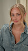 A video of a model wearing the North Star Big Necklace in silver, featuring a star-shaped pendant with a crystal, layered with a shorter, twisted herringbone-style silver necklace.