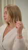 A model wearing a stack of silver jewelry. She wears the Santa Monica Bracelet with green onyx beads, the leaf-patterned Layers Olivia Bracelet, and the Bolded Ring.