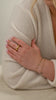 A video of a model showcasing the Santa Monica Bracelet in gold with green onyx stones spaced throughout, layered with a twisted bracelet and paired with a chunky gold ring.